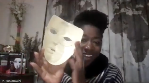 Dr. Joy Buolamwini holds the original white mask from her research on Unmasking AI.