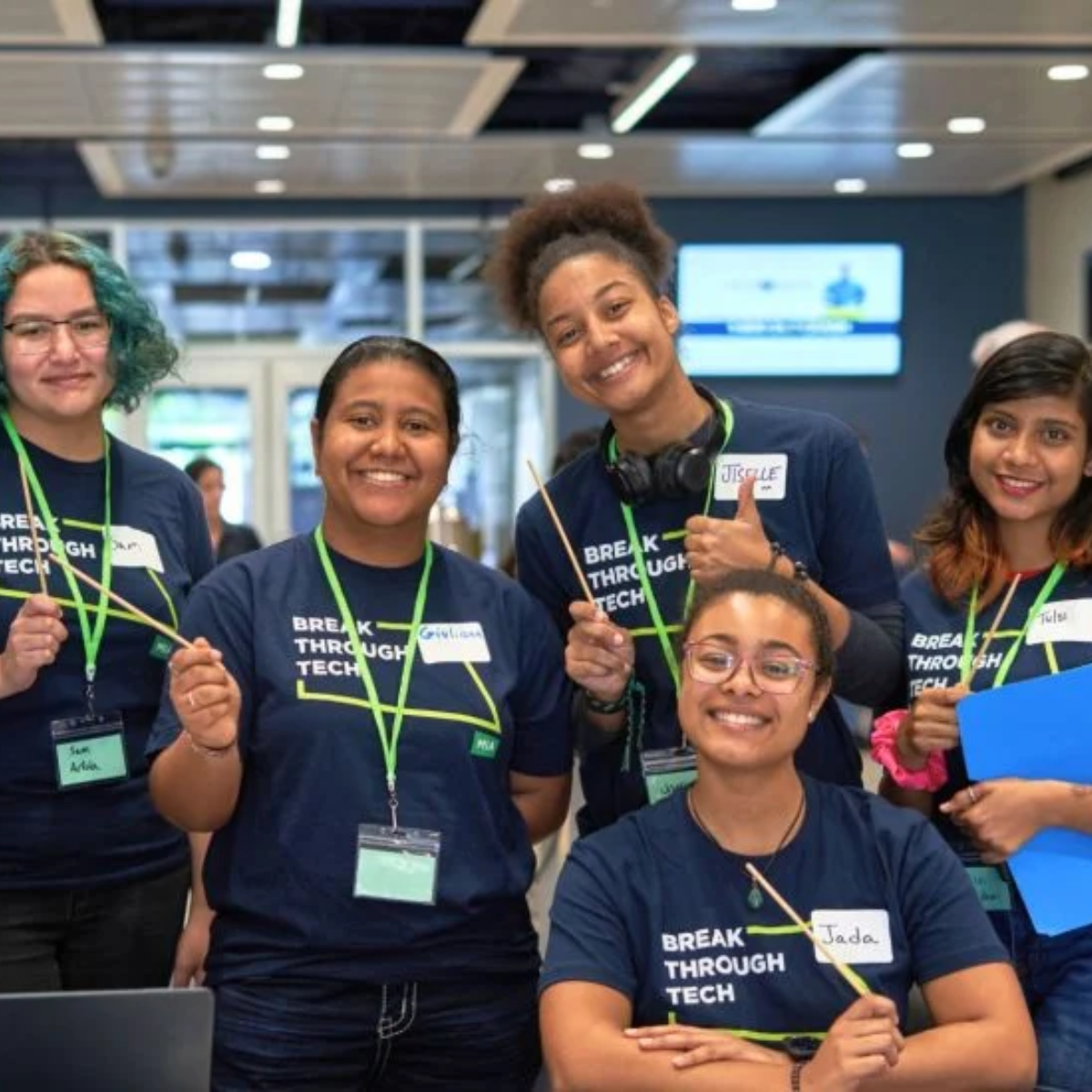 Five students pose for a photo. All students are wearing a Break Through Tech t-shirt.