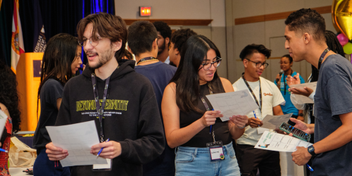 A group of undergraduate students at FIU work together to complete an icebreaker activity.